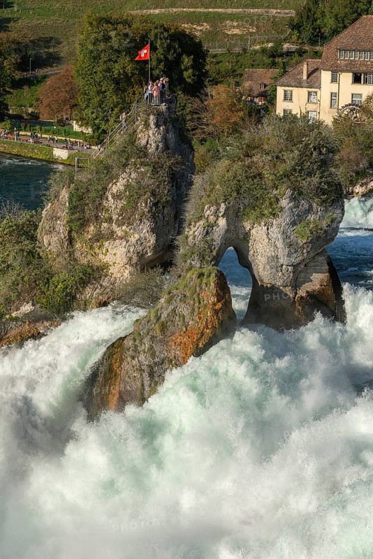 Rhine Falls seen from Laufen Castle, rocky island, Swiss flag, spray, Canton Zurich, on Neuhausen, Switzerland, Europe
