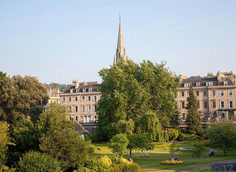 Parade Gardens public park in city centre of Bath, Somerset, England with church spire in background