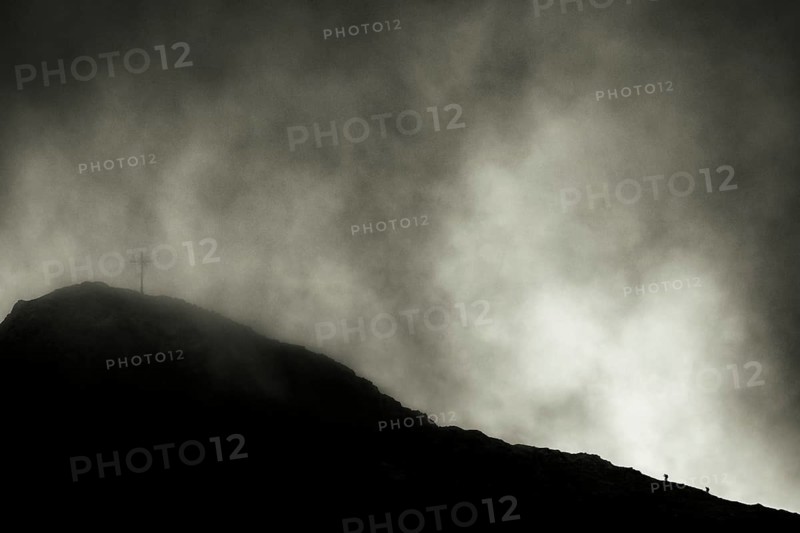 Summit of the Sulzfluh with ascending mountaineers and dramatic cloudy sky, Tschagguns, Rätikon, Montafon, Vorarlberg, Austria, Europe