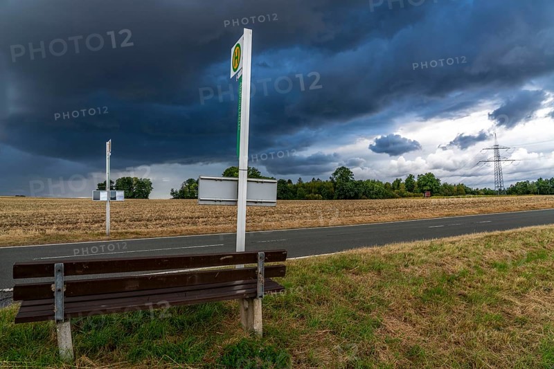 Single stop of bus line 510 between Korbach and Bad Wildungen, country road near Waldeck in North Hesse, bus stop Abzweig Netze, bus traffic between 6 a.m. and 5 p.m., NVV, Nordhessische VerkehrsVerbund, thunderstorm front approaching, Germany, Europe