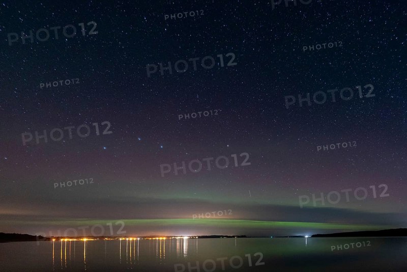 Northern lights (aurora borealis) shine on a starry night over Lake Plau, Ganzlin, Mecklenburg-Vorpommern, Germany, Europe