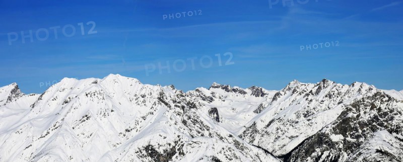 Alpine panorama with snow-covered mountain peaks in winter. Taken in the ski resort of Serfaus Fiss Ladis (Tyrol, Austria)
