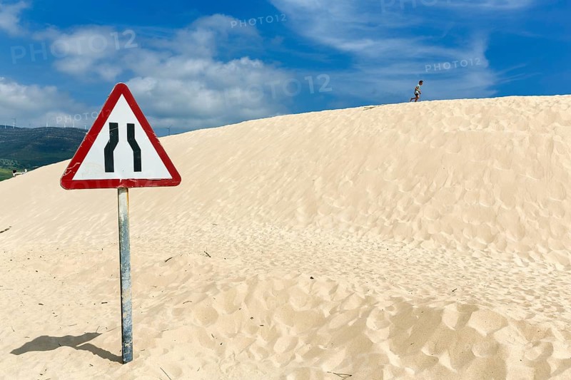 Moving dune with traffic sign, caution narrowed lane, narrowing of lane, dune, coastline near Valdevaqueros, Tarifa, Costa de la Luz, Spain, Europe