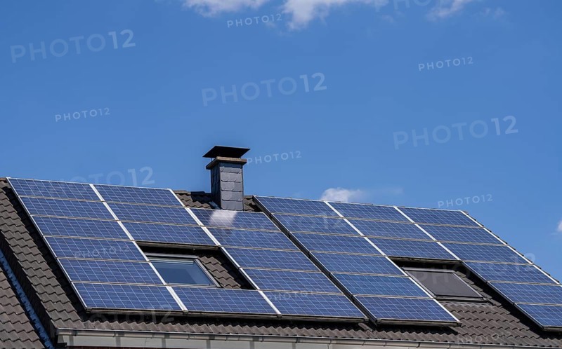 Solar system on the pitched roof of a residential building, photovoltaics for power generation, for own consumption and grid feed-in, North Rhine-Westphalia, Germany, Europe