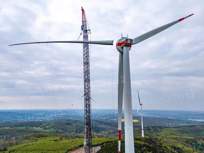 Erection of a wind turbine, wind energy plant, assembly of the third blade, with a crawler lattice crane, wind farm near Hagen, North Rhine-Westphalia, Germany, Europe
