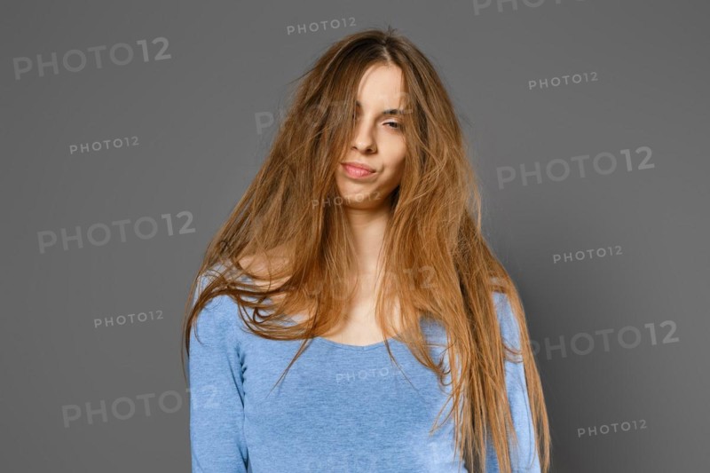 Portrait of annoyed woman with long tangled hair