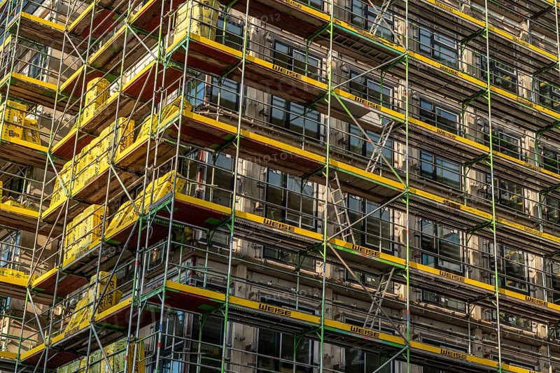 Construction site of a large building project on Huyssenallee in Essen, Huyssen Quartier, residential tower block with 19 floors, an office building with 5 floors, scaffolded new building, Essen, North Rhine-Westphalia, Germany, Europe