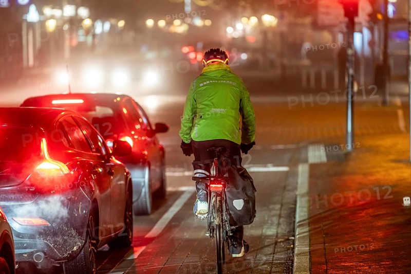 Cyclist, darkness, inner city traffic, Rüttenscheider Straße, bicycle lane, fog, autumn, winter, evening traffic, North Rhine-Westphalia, Germany, Europe