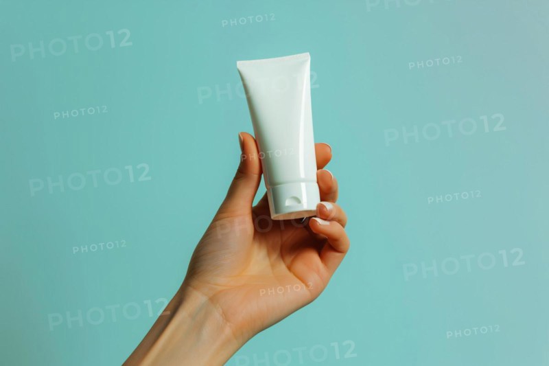 Close up of wind mill turbine covered in ic ein winterWoman's hand holding white cream tube in front of studio background. Generative AI, AI generated