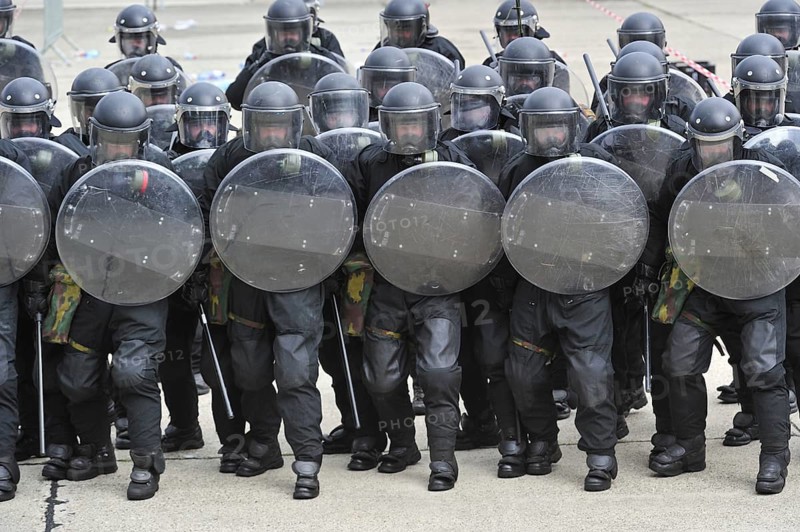 Demonstration of riot squad forming a protective barrier with riot shields during open day of the Belgian army at Leopoldsburg, Belgium, Europe