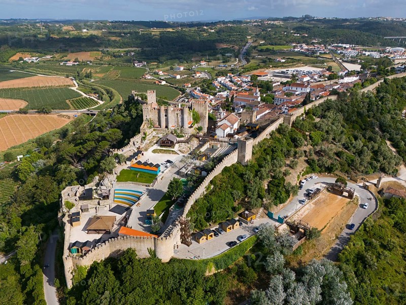 Aerial view of a large castle and fortress surrounded by trees and farmland showing historic architecture and defences, City, Castle, Castelo de Óbidos, City Wall, Óbidos, Obidos, Oeste, Centro, Estremadura, Portugal, Europe