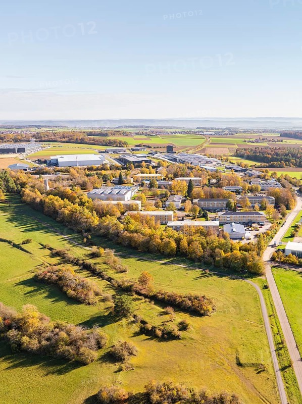 Panoramic view of an industrial area, surrounded by fields and autumnal forest, high ropes course, Nagold, Black Forest, Germany, Europe