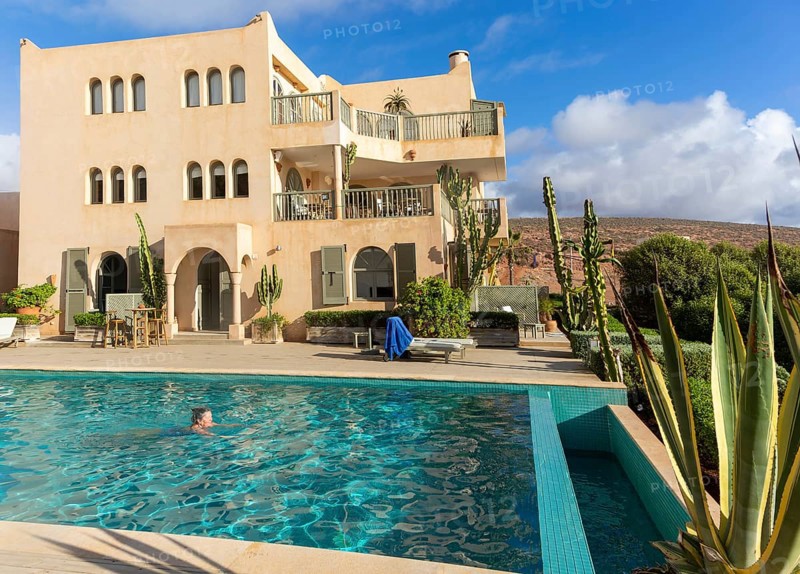 Woman swimming infinity pool by Hotel auberge Dar Najmat, Mirleft, Morocco, north Africa, Africa