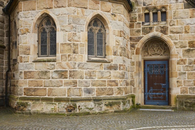 Facade of St Laurentius Church with stained glass windows and a side door in Warendorf, Warendorf district, North Rhine-Westphalia, Germany, Europe