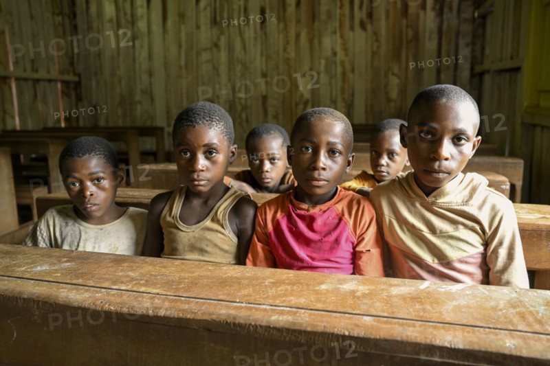 Pygmy children from the BaAka people at the school desk, Libongo, Est region, Cameroon, Africa