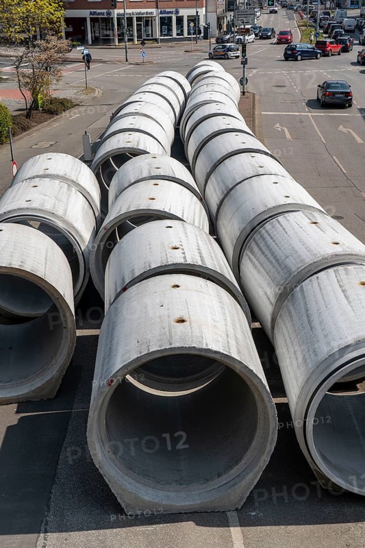 Concrete sewer pipes, stored on a construction site during sewer renovation work, on the Dickswall, city centre of Mülheim an der Ruhr, North Rhine-Westphalia, Germany, Europe