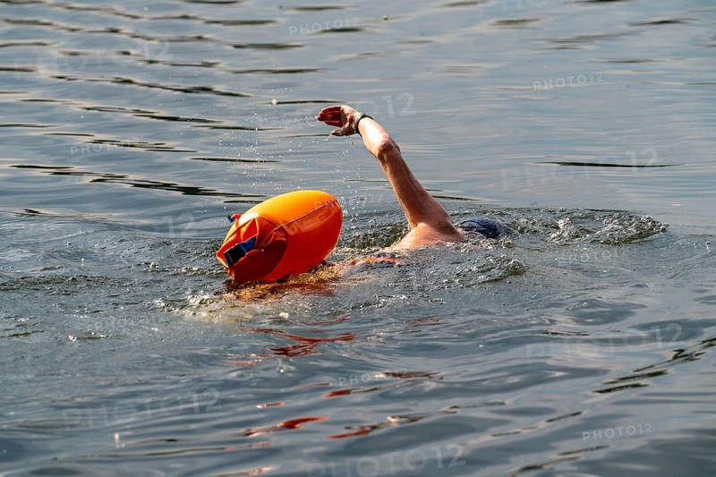 Open water swimmer, with marker buoy, in a lake, Wambachsee, 6-Seen-Platte, Duisburg, North Rhine-Westphalia, Germany, Europe