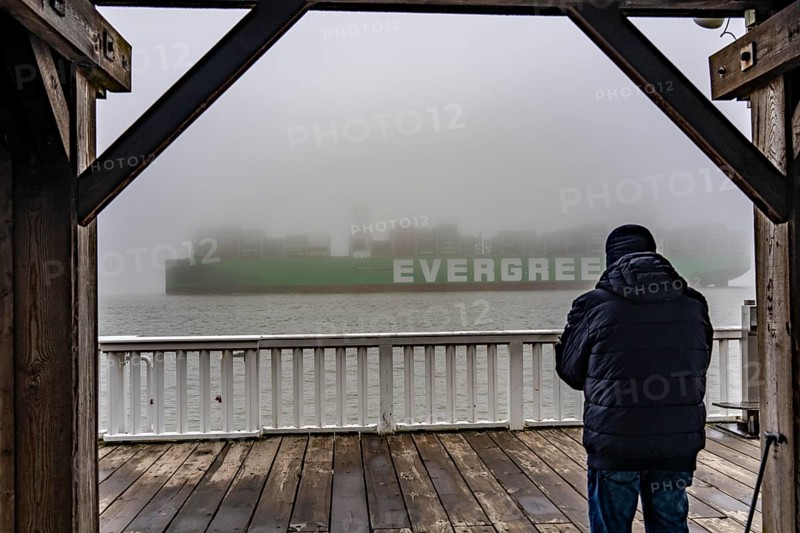 Thick fog in winter, hanging over the mouth of the Elbe into the North Sea, container ship Ever Arm, leaving the Elbe for Rotterdam, viewpoint Alte Liebe in Cuxhaven, Lower Saxony, Germany, Europe