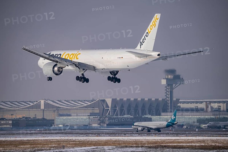 AeroLogic cargo aircraft, Boeing 777F approaching Frankfurt FRA airport, air traffic control tower, Fraport, in winter, Hesse, Germany, Europe