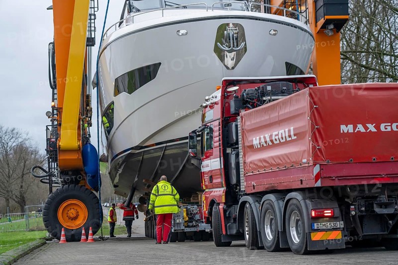 Craning the €6.3 million Sunseeker 88Y motor yacht, weighing 82 tonnes, in preparation for the world's largest water sports trade fair, Boot in Düsseldorf, luxury yachts are driven across the Rhine to the trade fair and brought ashore with the help of the Big Willi ship crane and transported to the exhibition halls on a low-loader, North Rhine-Westphalia, Germany, Europe