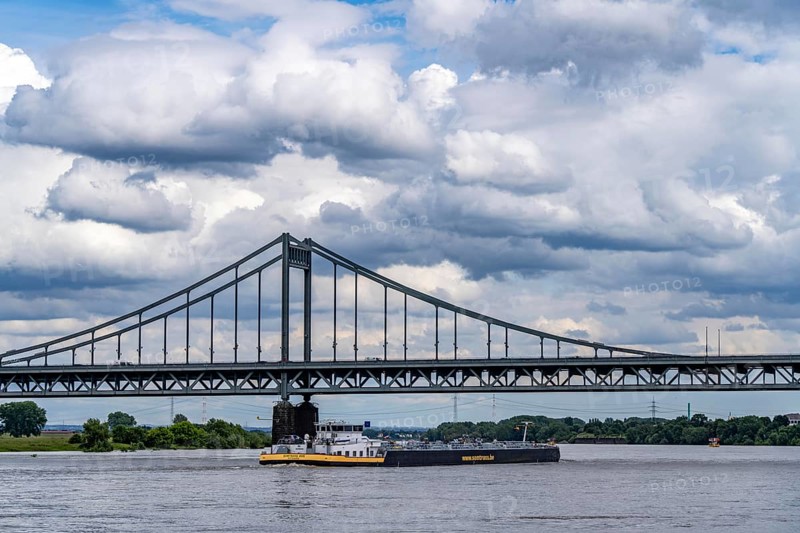 The Krefeld-Uerdingen Bridge over the Rhine, between Krefeld and Duisburg, bridle belt bridge from 1936, 858 metres long, federal road B228, shows severe bridge damage, restricted traffic on the bridge, to be replaced, cargo ship, North Rhine-Westphalia, Germany, Europe