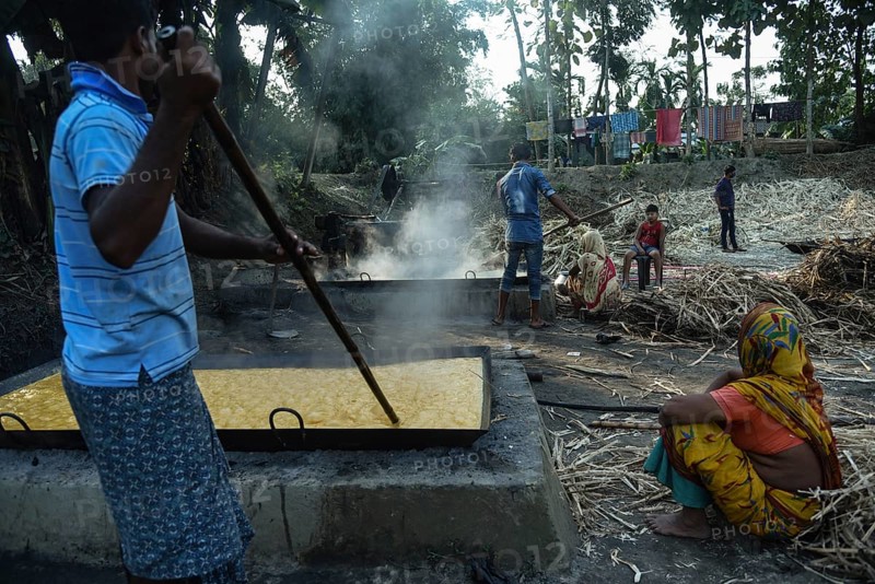 Workers boiling sugarcane juice as they are making Gur (jaggery) in a village on December 10, 2021 in Barpeta, Assam, India. Gur (jaggery) is a natural product of sugarcane, makes from raw, concentrated sugarcane juice, consumed in the Indian Subcontinent and Southeast Asia