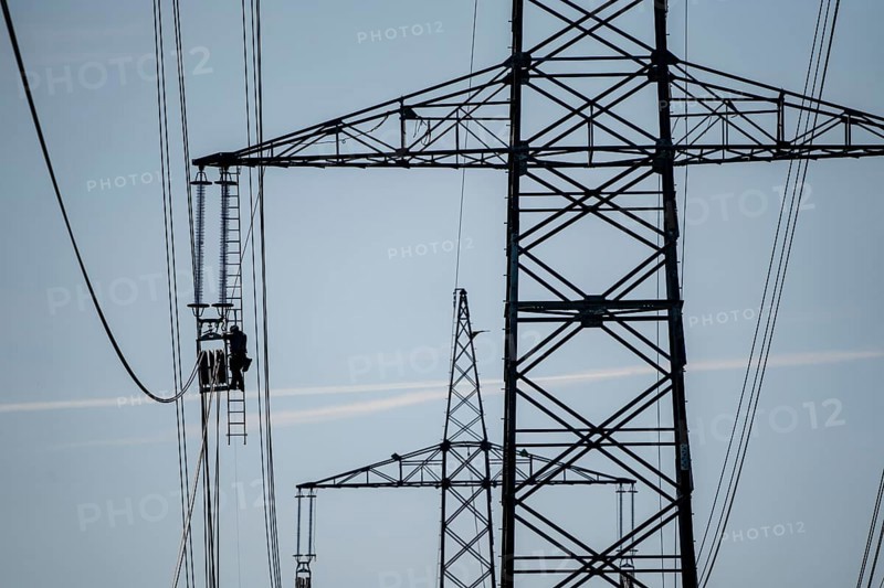Construction of a new line route, 380 KV extra-high voltage line between Osterath and Gohr, near Neuss, fitter on ladder at great height, tensioning the lines, North Rhine-Westphalia, Germany, Europe