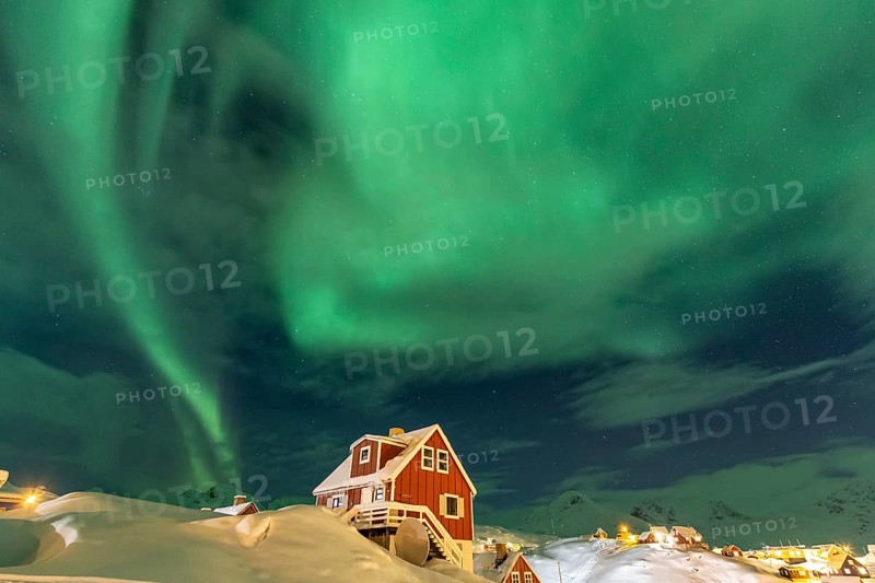 Northern Lights, Aurora borealis over red house, Inuit settlement, Winter, Tasiilaq, East Greenland, Greenland, North America