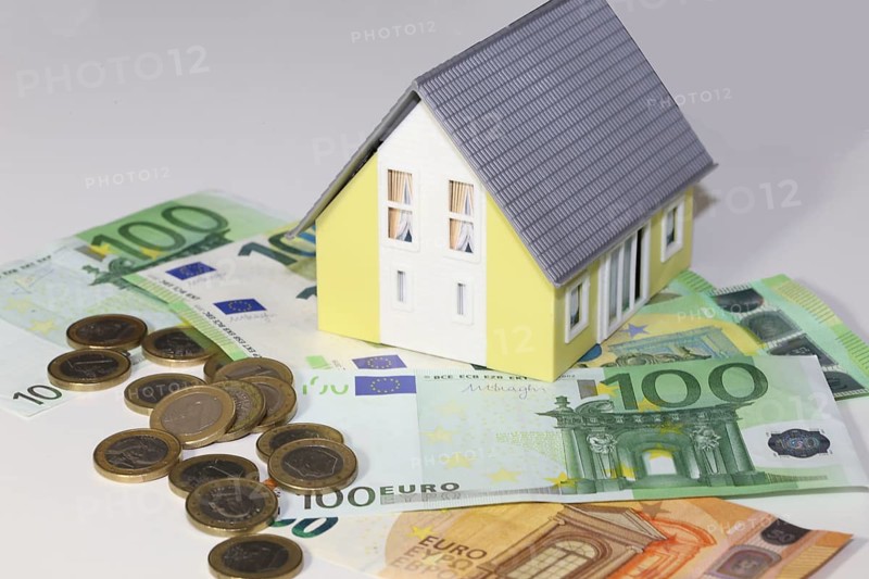 Concept photo with model house, euro notes and coins