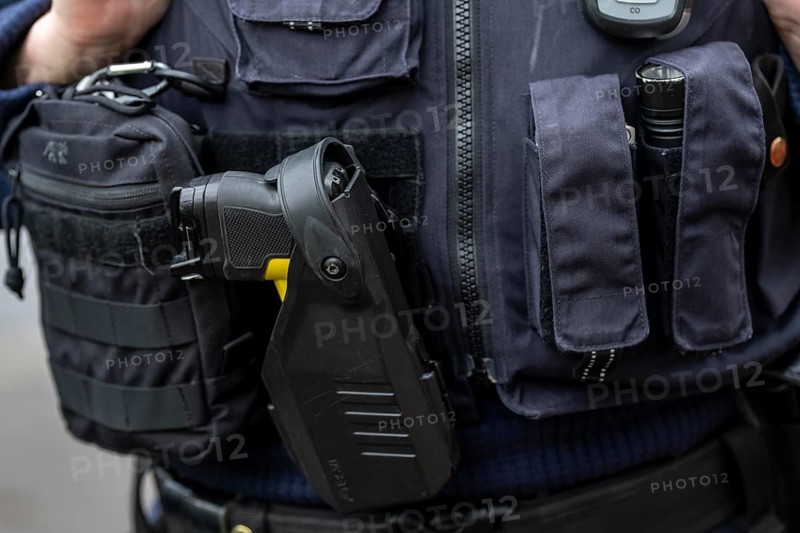 Police, policewoman with equipment waistcoat, first aid pack, taser, torch, handcuffs, North Rhine-Westphalia, Germany, Europe