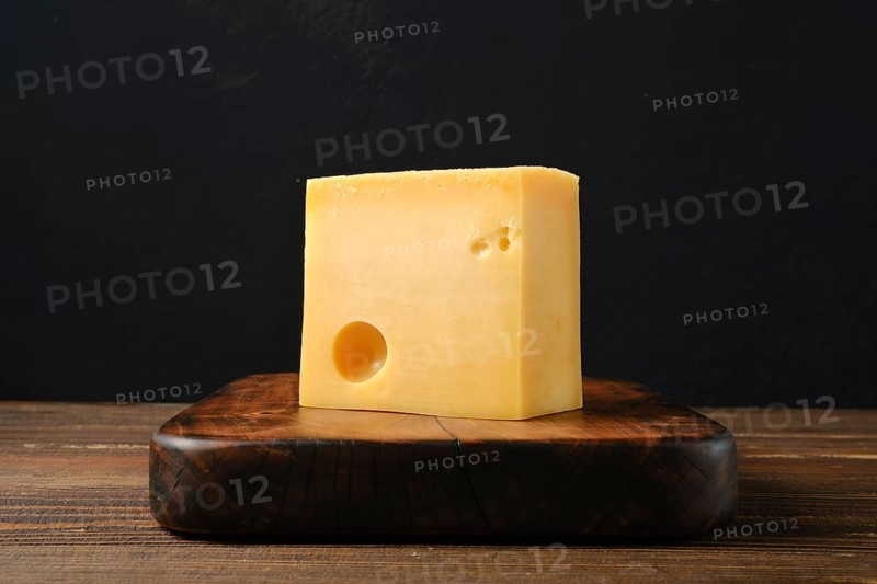 Block of Swiss cheese on cutting board
