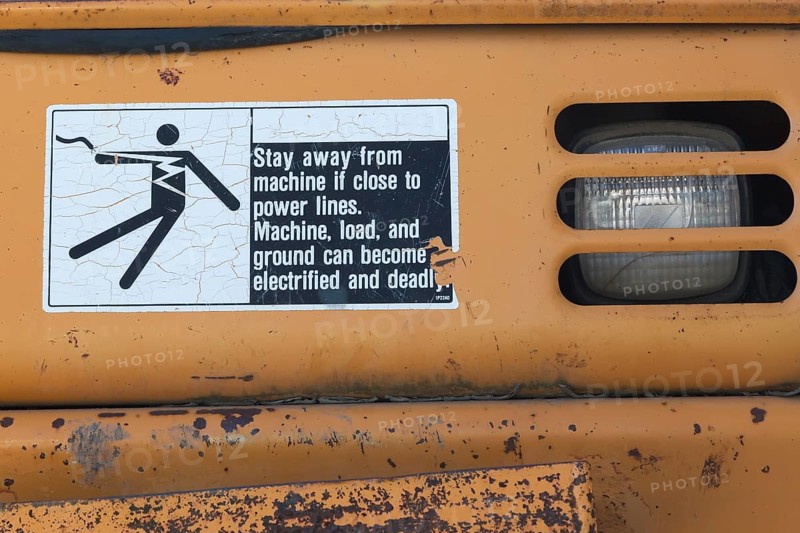 Pictogram and written danger warning sticker on heavy duty backhoe excavator, Quebec, Canada, North America