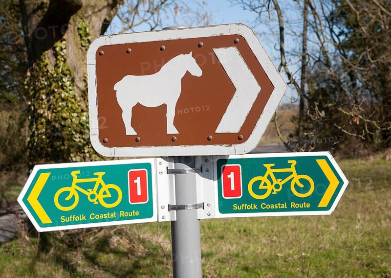 Sign for cycle route and pointing to Suffolk Punch horse tourist attraction of Easton Farm Park, at Hoo, Suffolk, England, United Kingdom, Europe