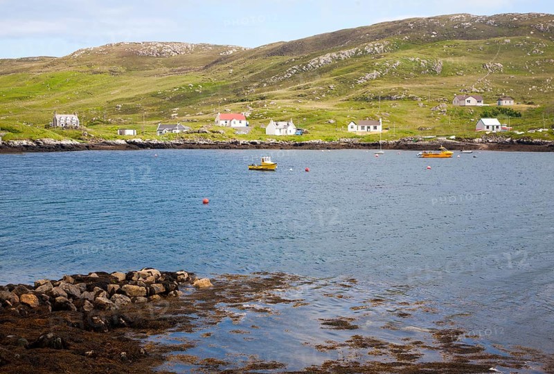 Croft houses along the shoreline at Leidag, Castlebay, Barra, Outer Hebrides, Scotland, UK