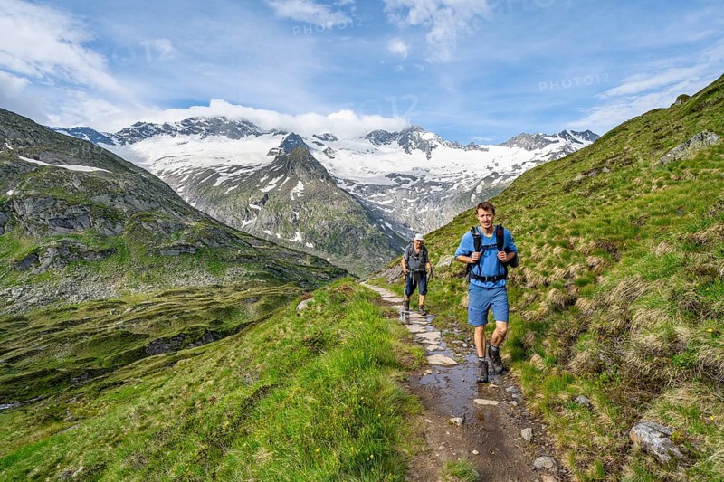 Two mountaineers on a hiking trail in a picturesque mountain landscape, mountain peak with snow and glacier Hornkees and Waxeggkees, summit Hornspitzen and Großer Möseler, Berliner Höhenweg, Zillertal Alps, Tyrol, Austria, Europe