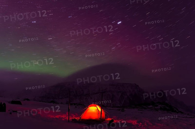 Northern Lights (Aurora borealis) and star trails above an illuminated tent in the valley Stuor Reaiddávággi, Kebnekaisefjaell, Norrbotten, Lapland, Sweden, Bivouac, Scandinavia, Europe