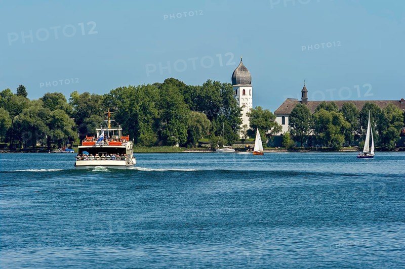 Bell tower of the church of St Irmengard, Benedictine monastery Frauenwörth, Frauenchiemsee or Fraueninsel, passenger ship, excursion boat with stern wave, Chiemsee, Chiemgau, Upper Bavaria, Bavaria, Germany, Europe