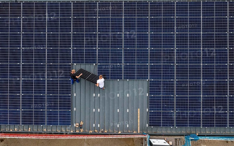 Installation of solar modules on the roof of a barn on a farm, over 210 photovoltaic modules are installed on the roof, North Rhine-Westphalia, Germany, Europe