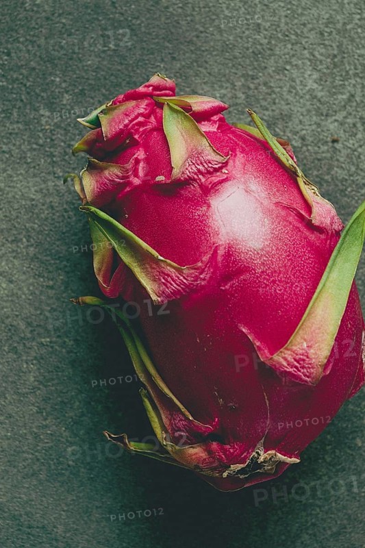 Dragon fruit, pitahaya, one piece, top view, rustic style, green background