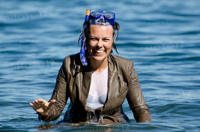 Elegant and Happy Business Wet Woman in the Water with a Diving Mask and a Elegant Suit in Switzerland
