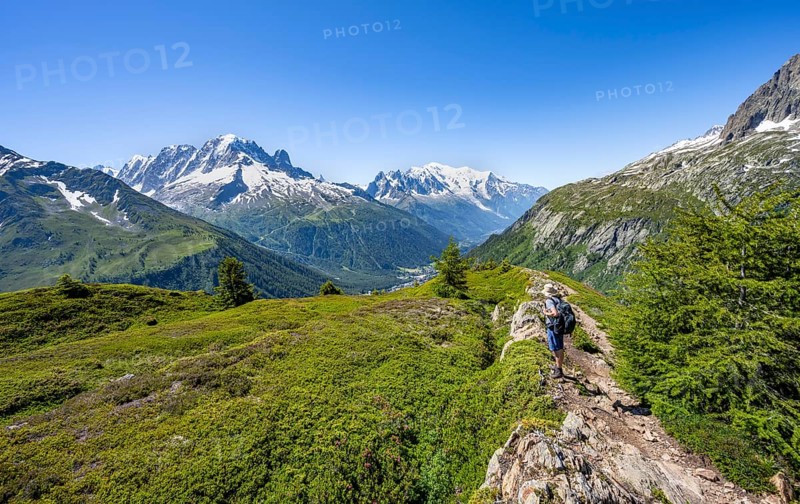 Mountaineer in front of a mountain panorama with glaciated mountain peaks, Aiguille Verte with Aiguille du Midi and Mont Blanc, hike to Aiguillette des Posettes, Chamonix, Haute-Savoie, France, Europe