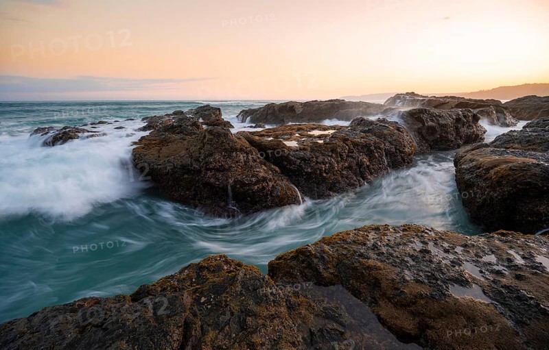 Waves washing over rocks by the sea, long exposure, coastal landscape at sunset, Playa Cocalito, Pacific coast, Nicoya Peninsula, Puntarenas province, Costa Rica, Central America