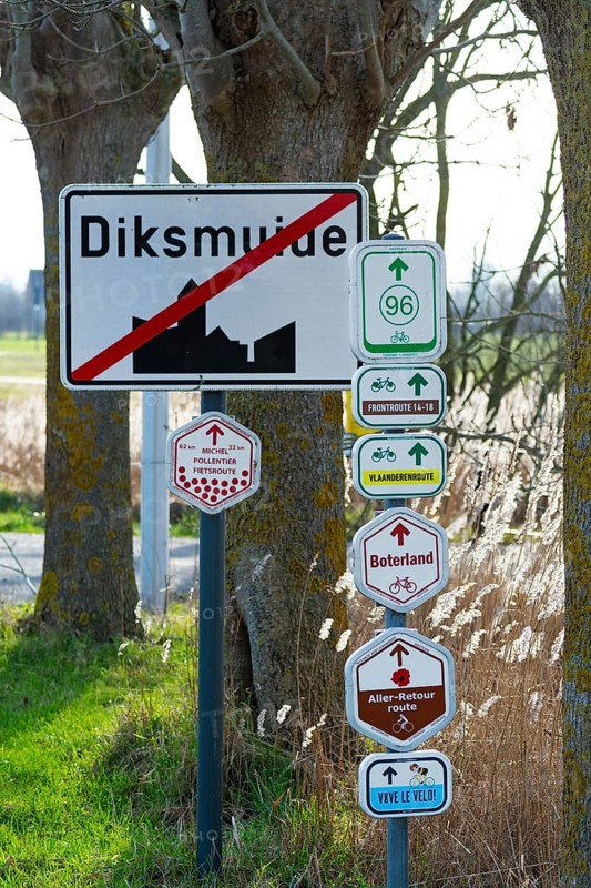 Bike node sign and 14-18 front route signposts giving directions for cycling routes, bicycle tourism at Diksmuide, Dixmude, West Flanders, Belgium, Europe