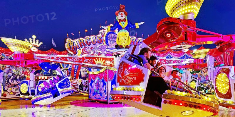 People in the illuminated carousel Circus Circus in the evening, Cranger Kirmes, Herne, Ruhr area, North Rhine-Westphalia, Germany, Europe