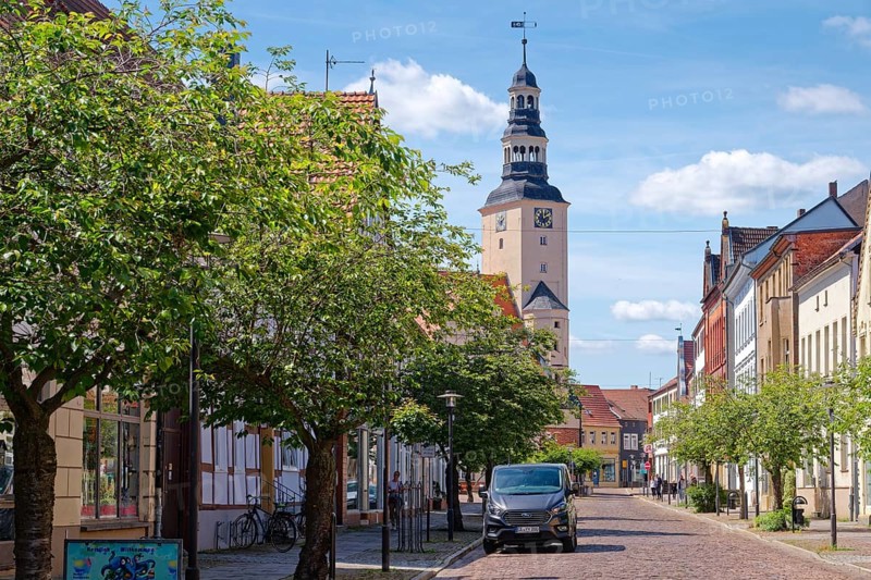 Residential and commercial buildings in Rudolf-Breitscheid-Straße, paved with cobblestones, in the old town centre of Gardelegen in the Altmark, with the town hall in the background. Hanseatic town of Gardelegen, Saxony-Anhalt, Germany, Europe