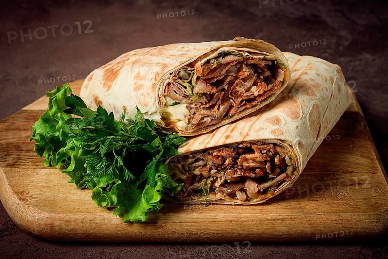 Cut shawarma, 2 pieces, on a cutting board, close-up