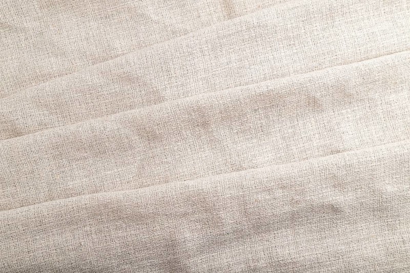 Fragment of white linen tissue. Top view, flat lay, natural textile background and texture. wave concept, abstract
