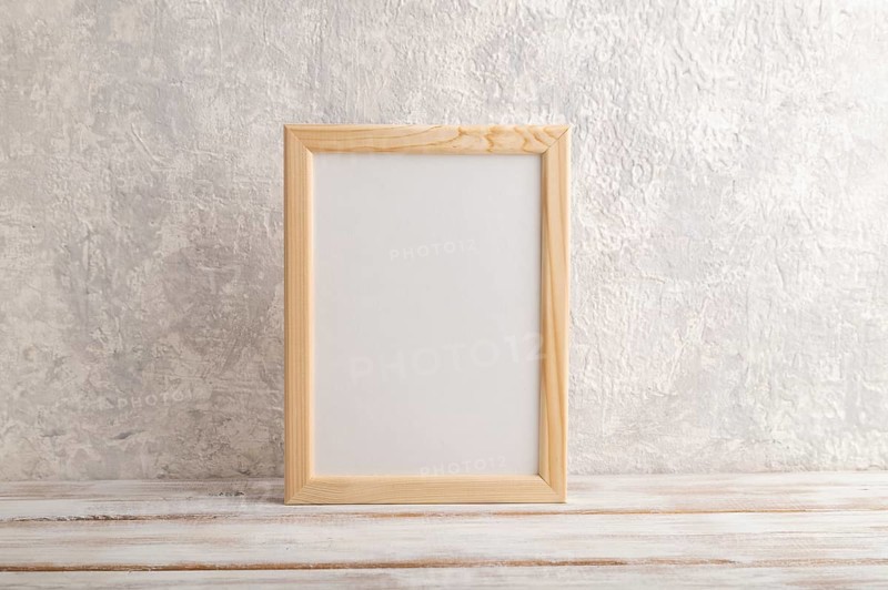 White wooden frame mockup on gray concrete background. Blank, vertical orientation, still life, copy space