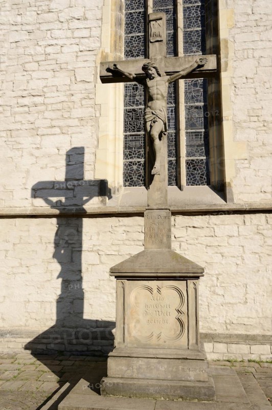 Jesus Christ on the cross in front of the parish church of St Christophorus, Werne, North Rhine-Westphalia, Germany, Europe