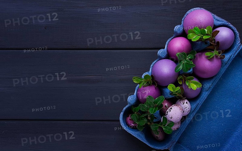 Easter eggs, purple and lilac, on a gray wooden table, Easter card, banner, selective focus, horizontal